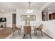 Dining room with glass table, modern chandelier, and neutral decor at 10850 W Avenida Del Rey --, Peoria, AZ 85383