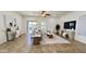 An open-plan living room area with a sliding glass door, ceiling fan, neutral color palette, and stylish furnishings at 10850 W Avenida Del Rey --, Peoria, AZ 85383