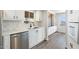 Kitchen featuring stainless steel dishwasher and sink, white cabinetry, and tile backsplash at 11411 N 91St Ave Ave # 87, Peoria, AZ 85345