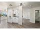Well-lit kitchen featuring modern white cabinetry, tile backsplash, and laminate flooring at 11411 N 91St Ave Ave # 87, Peoria, AZ 85345