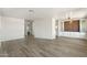 Spacious living room with hardwood floors, white walls, and custom dining room build-ins at 11411 N 91St Ave Ave # 87, Peoria, AZ 85345