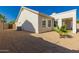 Manicured backyard with gravel landscaping, small palm tree, and modern home exterior at 1213 W Beck Ln, Phoenix, AZ 85023
