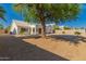 Well-kept backyard featuring mature trees, gravel landscaping, and a white home exterior at 1213 W Beck Ln, Phoenix, AZ 85023