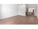 Large bedroom with wood-style flooring, white walls, and ensuite bathroom access at 1213 W Beck Ln, Phoenix, AZ 85023