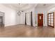 Bright dining room with hardwood-style floors, chandelier, and adjacent front door entrance at 1213 W Beck Ln, Phoenix, AZ 85023
