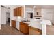 Bright kitchen featuring wooden cabinets, stainless steel sink, and wood-style floors at 1213 W Beck Ln, Phoenix, AZ 85023