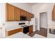 Functional kitchen with white countertops, wooden cabinets, and modern appliances at 1213 W Beck Ln, Phoenix, AZ 85023