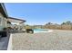 Spacious backyard with a pool, seating area, grassy area, and surrounding rocks, perfect for outdoor fun at 13842 N 40Th Ave, Phoenix, AZ 85053