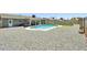 Inviting backyard features a sparkling blue pool, covered patio, and low-maintenance gravel landscaping at 13842 N 40Th Ave, Phoenix, AZ 85053