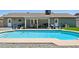Inviting backyard with a sparkling pool, patio seating area, and a lush green lawn, perfect for outdoor enjoyment at 13842 N 40Th Ave, Phoenix, AZ 85053