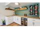 Custom bar featuring wine storage, floating shelves, granite countertops, and a beverage refrigerator at 13842 N 40Th Ave, Phoenix, AZ 85053