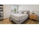 Comfortable bedroom showcasing a cozy bed, bright window and a stylish nightstand on a wood-look floor at 13842 N 40Th Ave, Phoenix, AZ 85053