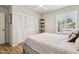 Comfortable bedroom featuring a large closet, bright window, and a cozy bed on a wood-look floor at 13842 N 40Th Ave, Phoenix, AZ 85053