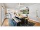 Open-concept dining area with modern lighting, and seamless access to the kitchen at 13842 N 40Th Ave, Phoenix, AZ 85053