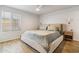 Serene bedroom with a large window, wood-look floors, and ample natural light at 13842 N 40Th Ave, Phoenix, AZ 85053