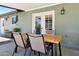 Outdoor patio space featuring a dining table with four chairs and lush plantings, perfect for backyard dining at 13842 N 40Th Ave, Phoenix, AZ 85053