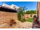 Spacious desert backyard with rock landscaping, privacy wall, and seating area at 14428 W Moccasin Trl, Surprise, AZ 85374