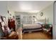 Comfortable bedroom with hardwood floors, a vintage-style bed frame, a window with shutters, and built-in bookshelves at 14428 W Moccasin Trl, Surprise, AZ 85374