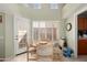 Cozy breakfast nook featuring a round table, comfortable chairs, and natural light from windows and a door to an outdoor patio at 14428 W Moccasin Trl, Surprise, AZ 85374