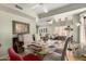 Cozy dining area with a glass-top table, decorative lighting, and views into other living spaces at 14428 W Moccasin Trl, Surprise, AZ 85374
