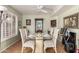 Dining room featuring a glass table set for a meal, bright lighting, and neutral colors at 14428 W Moccasin Trl, Surprise, AZ 85374
