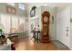Inviting entryway with high ceilings, wood floors, and a charming grandfather clock at 14428 W Moccasin Trl, Surprise, AZ 85374