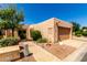 Charming single-story home with desert landscaping and a two-car garage at 14428 W Moccasin Trl, Surprise, AZ 85374