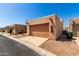 Single-story home with a two-car garage in a well-maintained community at 14428 W Moccasin Trl, Surprise, AZ 85374