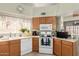 Well-lit kitchen featuring ample counter space, white appliances, and a view of the backyard at 14428 W Moccasin Trl, Surprise, AZ 85374