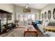 Bright living room with vaulted ceilings, white shutters, and a decorative rug, perfect for relaxation at 14428 W Moccasin Trl, Surprise, AZ 85374