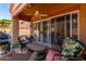 Inviting covered patio with ceiling fan and sliding glass doors offers a relaxing outdoor space at 14428 W Moccasin Trl, Surprise, AZ 85374
