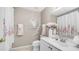 Bright bathroom features a white vanity, decorative mirror, floral accents, and white shower curtain at 15252 N 100Th St # 1164, Scottsdale, AZ 85260