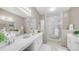 Bright bathroom with dual sinks, white cabinetry, a spacious glass enclosed shower, and a large mirror at 15252 N 100Th St # 1164, Scottsdale, AZ 85260