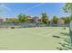 Enjoy a game of tennis on the community court, surrounded by lush landscaping and well-maintained fencing at 15252 N 100Th St # 1164, Scottsdale, AZ 85260