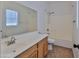 Bright bathroom featuring vanity, toilet, shower/tub combo, and large mirror at 15354 W Caribbean Ln, Surprise, AZ 85379