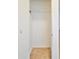 Empty coat closet featuring tile flooring and white wire shelf with hook for hanging coats and jackets at 15354 W Caribbean Ln, Surprise, AZ 85379