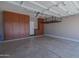 Spacious two-car garage with ample storage cabinets and ceiling racks to maximize space and organization at 15354 W Caribbean Ln, Surprise, AZ 85379