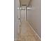 Hallway featuring tile floors and neutral paint leading to different rooms at 15354 W Caribbean Ln, Surprise, AZ 85379