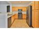 Well-equipped kitchen features stainless steel appliances, light wood cabinets, and tile flooring at 15354 W Caribbean Ln, Surprise, AZ 85379