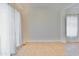Bright living room features tile flooring and a large window with elegant, light-filtering curtains at 15354 W Caribbean Ln, Surprise, AZ 85379