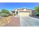 Charming single-story home featuring a two-car garage and a well-maintained, low maintenance front yard at 16389 N 180Th Dr, Surprise, AZ 85388