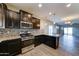 Modern kitchen featuring stainless steel appliances, granite countertops, dark wood cabinets, and a decorative tile backsplash at 16389 N 180Th Dr, Surprise, AZ 85388