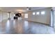 Bright open floor plan featuring wood-look tile floors, ceiling fan, and a view of the kitchen at 16389 N 180Th Dr, Surprise, AZ 85388