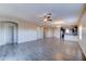 Open-concept living room with wood-look tile floors, high ceilings, and lots of natural light at 16389 N 180Th Dr, Surprise, AZ 85388