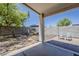 Charming covered patio with stone flooring, a hammock and seating offer an outdoor oasis at 16523 W Desert Bloom St, Goodyear, AZ 85338