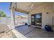 Covered patio features a ceiling fan, sliding glass door, and access to outdoor living space at 16523 W Desert Bloom St, Goodyear, AZ 85338