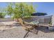 Relaxing backyard featuring a hammock, mature tree, and ample space for outdoor enjoyment at 16523 W Desert Bloom St, Goodyear, AZ 85338
