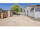 Spacious backyard with a storage shed, mature trees, and ample room for landscaping or play at 16523 W Desert Bloom St, Goodyear, AZ 85338