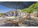 View of the backyard featuring a hammock, shade umbrella, and views of the home at 16523 W Desert Bloom St, Goodyear, AZ 85338