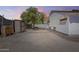 Home's backyard featuring a storage shed and a hammock, surrounded by desert landscape at 16523 W Desert Bloom St, Goodyear, AZ 85338